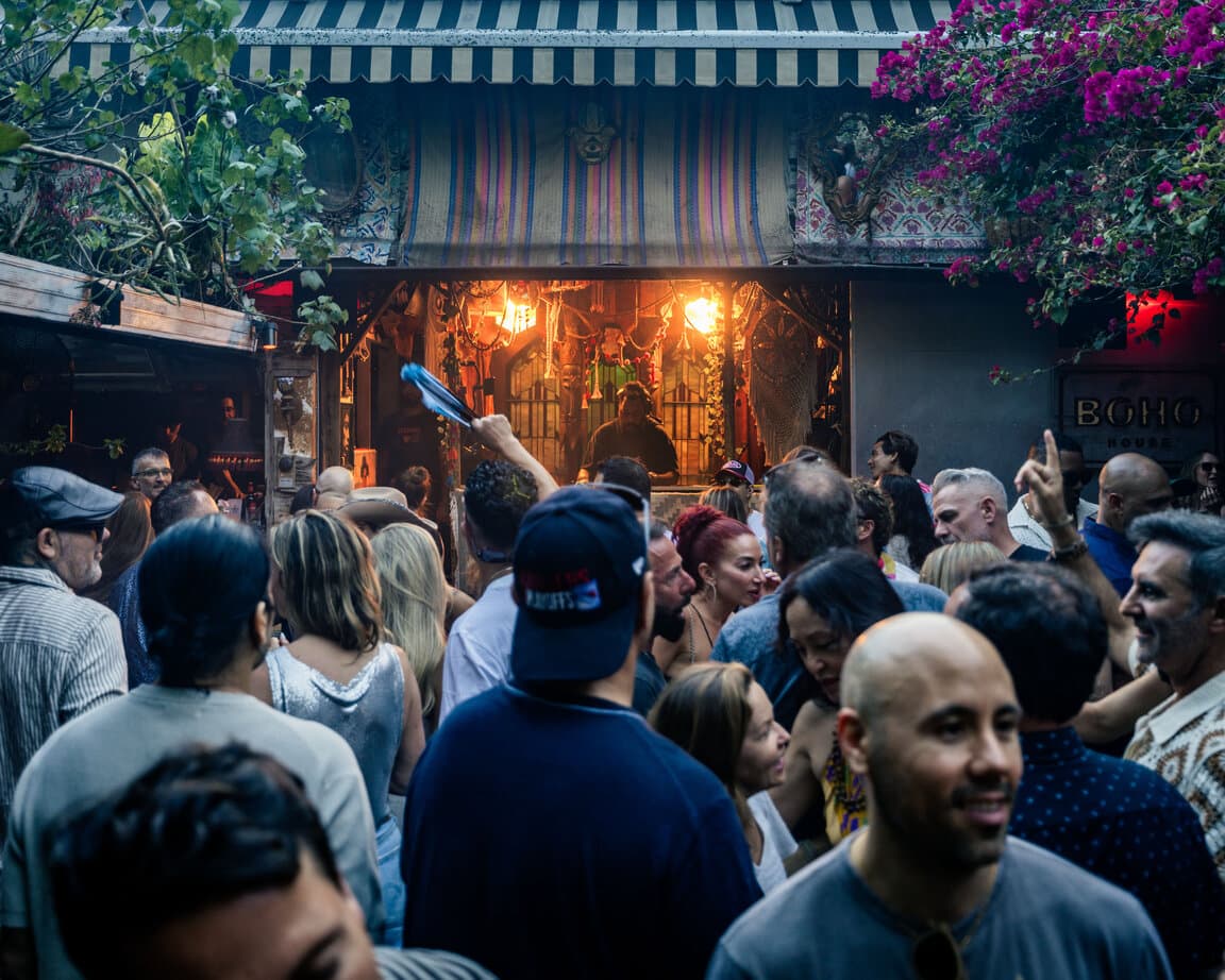 Packed crowd under the bougainvillea